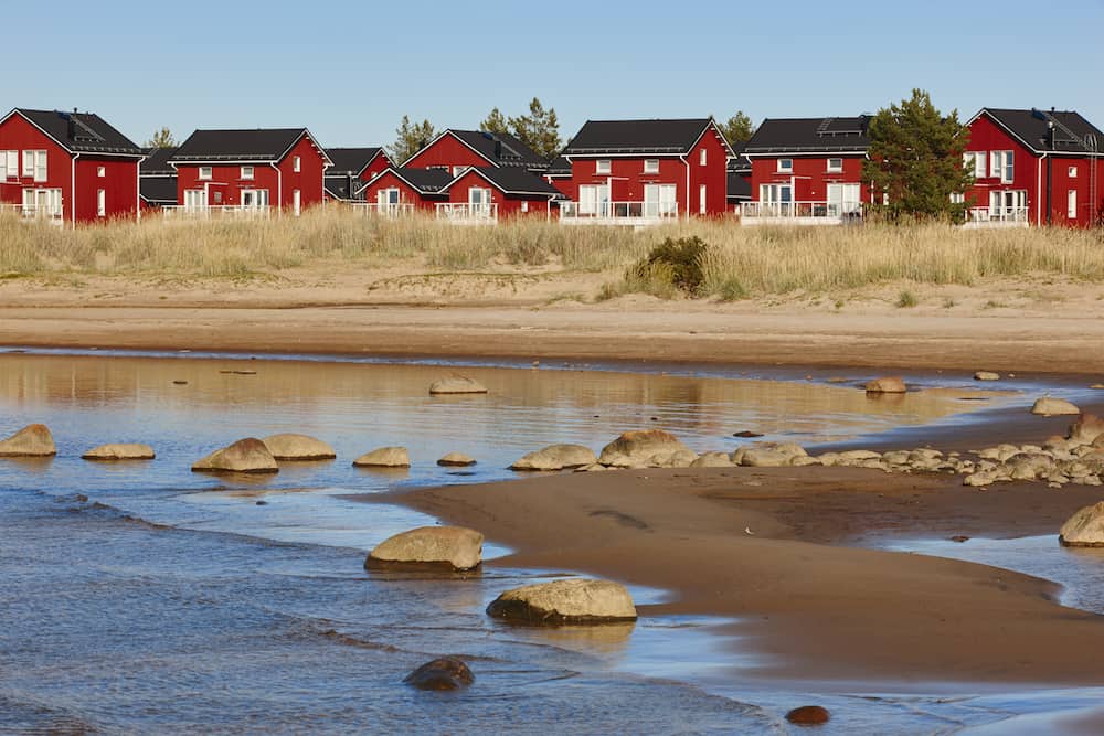 Red wooden houses near Marjaniemi beach Hailuoto island. Finland. Travel