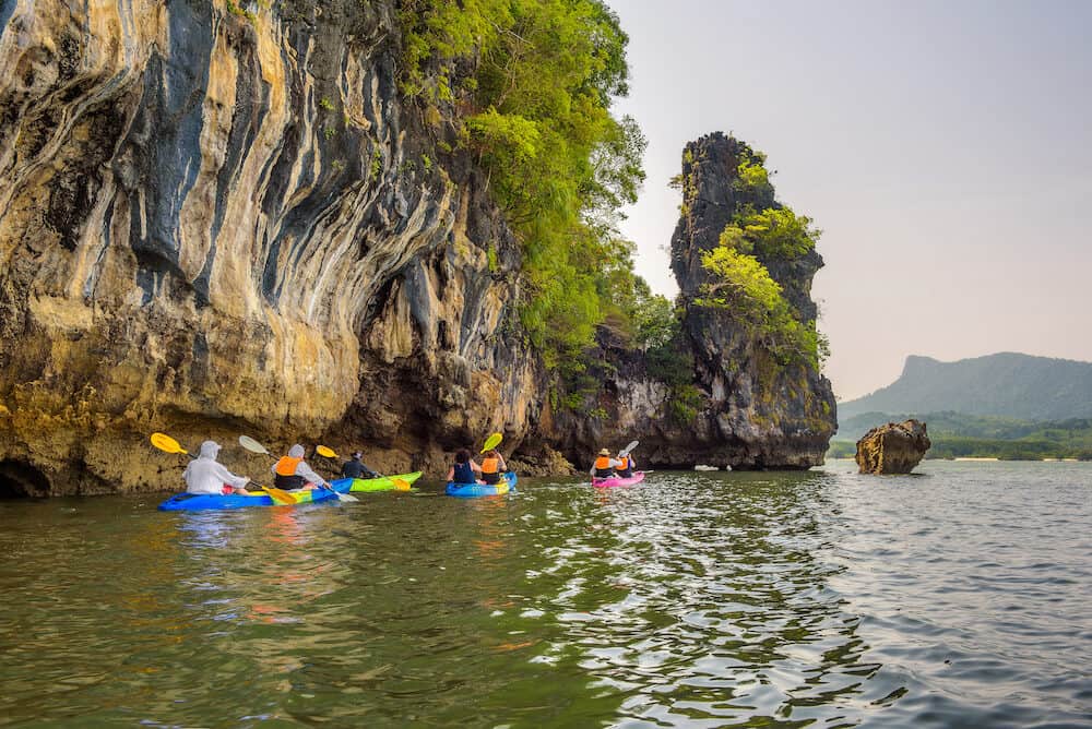 Phang Nga Bay, Thailand - Group of tourists kayaking into mangrove jungle of Krabi in Thailand