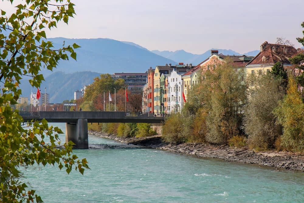Innsbruck, Austria - Beautiful architecture in city center of the historic city center of Innsbruck with colorful houses along Inn river and famous Austrian mountain in the background - Innsbruck, Austria- Image