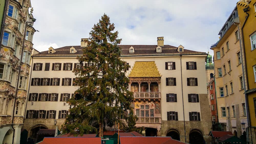 Traditional christmas market and tree near Goldenes Dachl (Golden roof) in the center of Innsbruck, Austria