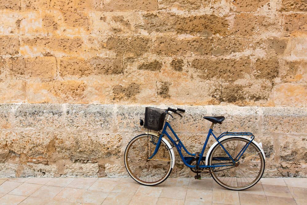 Bicycle in historical Ciutadella stone wall at Balearic islands