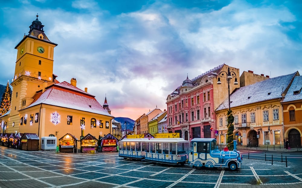 Brasov, Romania - Christmas Market in Piata Sfatului square, Landmark and traditional city train of Transylvania