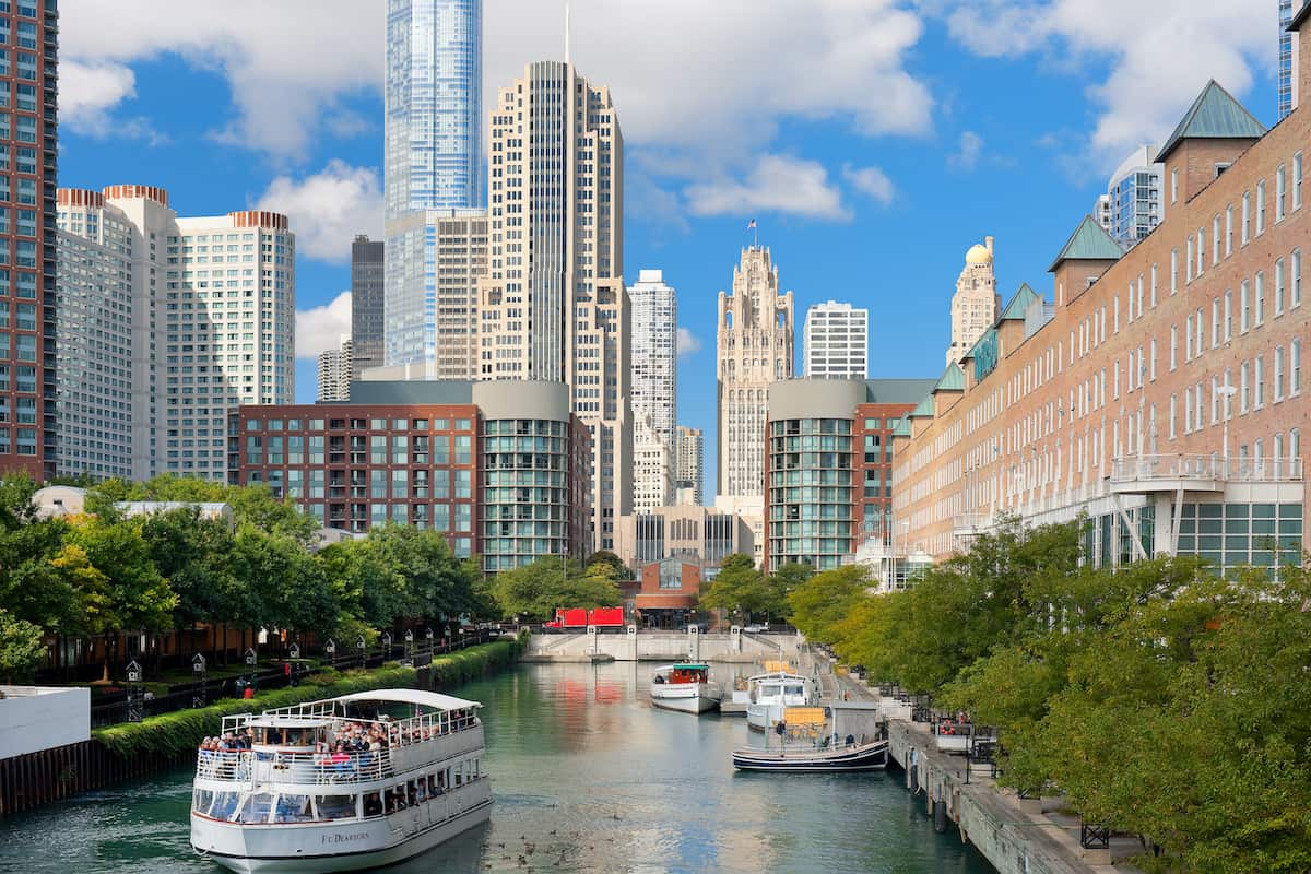 Sightseeing boat with tourists on the Chicago river in the Chicago Loop in Chicago. The Loop is one of Chicago district and the seat of Chicago's government.