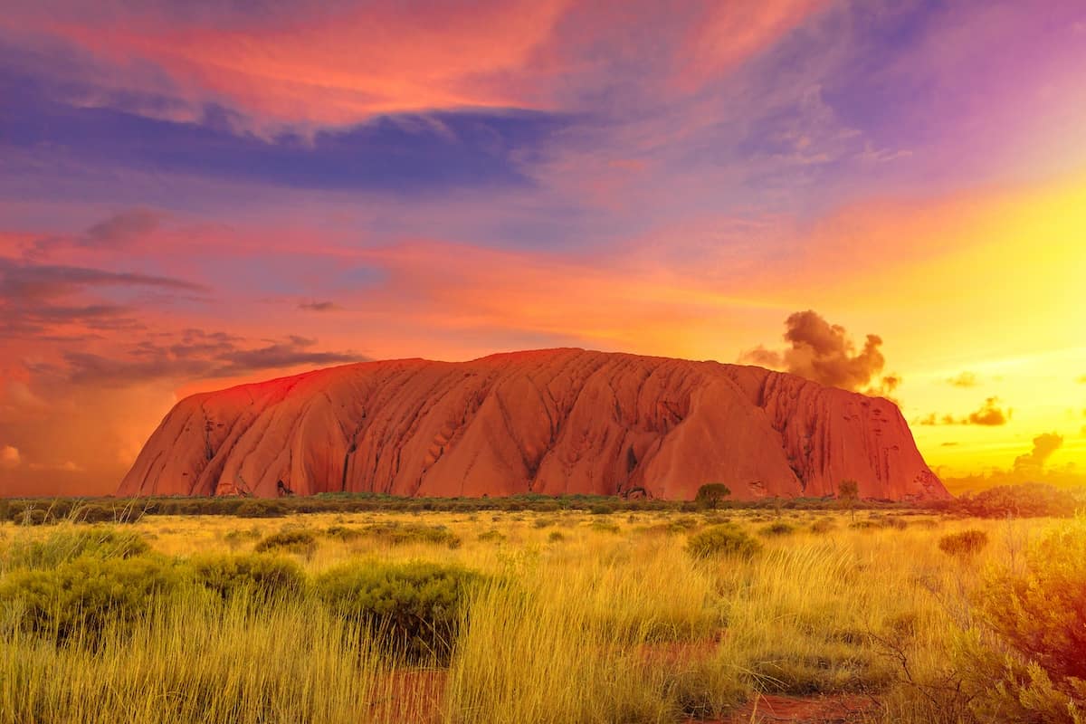 Uluru, Northern Territory, Australia - Colorful clouds at sunset sky over Ayers Rock in Uluru-Kata Tjuta National Park, Living Cultural Landscape. Majestic australian outback Red Center